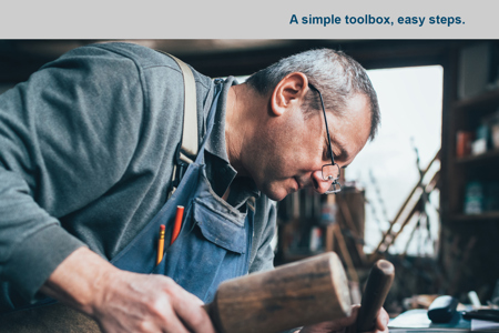 The front cover of the booklet which shows the text 'Renovate your relationship - a manual for men', a man performing woodwork, and the Relationships Australia logo