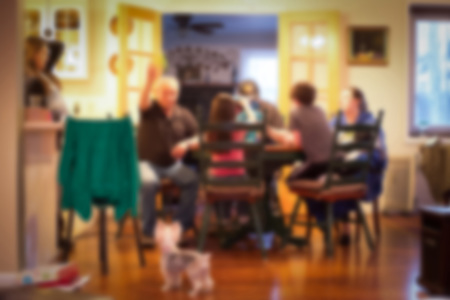 A family sitting together at a dining table. 