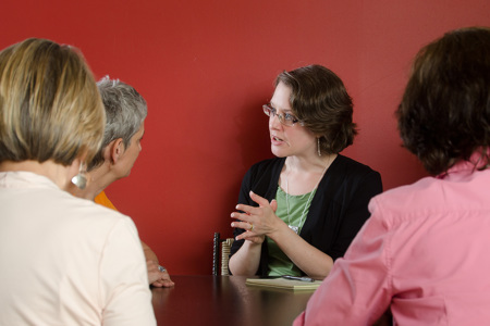 Four people sitting at a table talking. 