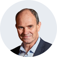 Andrew Bickerdike, a smiling middle-aged man of Anglo-Saxon descent, wearing a navy suit jacket and pale blue collared shirt