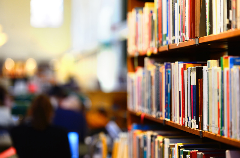 A bookcase full of books in a library.