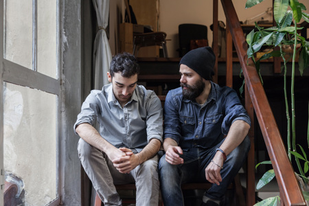 A couple sitting together on a staircase.