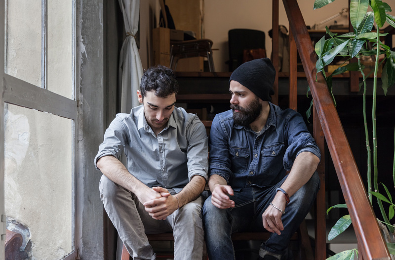 A couple sitting together on a staircase.