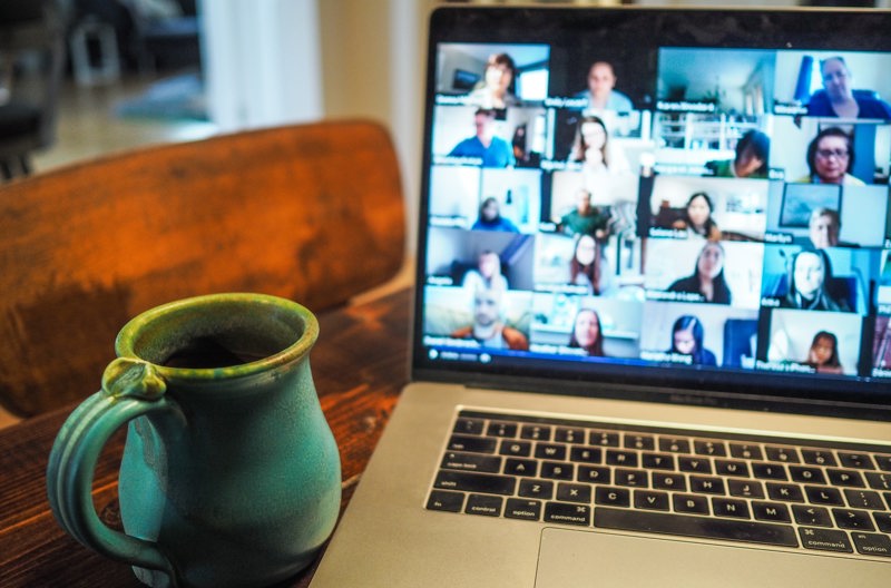 A person on a video call through their laptop talking with another person. 