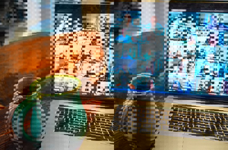 A landscape of mountains in the distance with a cloudy pink sky above.